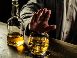 man turning down whisky Rising Muscle | Home